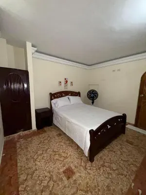 a bedroom with a large bed in a room at Hotel San Francisco Inn in Barranquilla