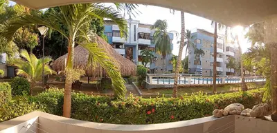 a view of a resort with a pool and palm trees at Vikingos de Tolú, a un Salto de las Islas in Tolú