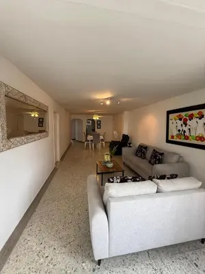 a living room with a couch and a table at Barrio El Golf Apartment in Barranquilla