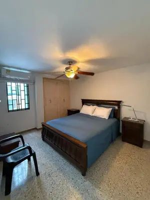 a bedroom with a bed and a ceiling fan at Barrio El Golf Apartment in Barranquilla