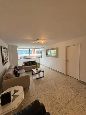 a living room with a couch and a table at Barrio El Golf Apartment in Barranquilla