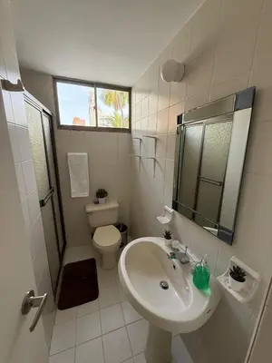 a white bathroom with a sink and a toilet at Barrio El Golf Apartment in Barranquilla