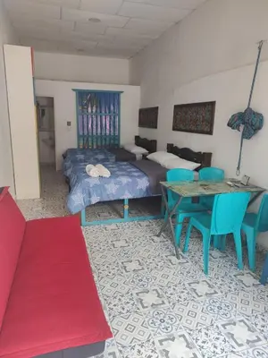 a bedroom with a bed and a table and chairs at Getsemani ballestrinqe in Cartagena de Indias