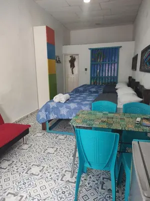 a bedroom with a bed and two tables and chairs at Getsemani ballestrinqe in Cartagena de Indias