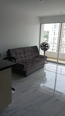 a living room with a couch and a large window at Edificio Lotus Torices Cartagena in Cartagena de Indias