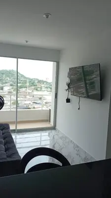 a living room with a couch and a large window at Edificio Lotus Torices Cartagena in Cartagena de Indias