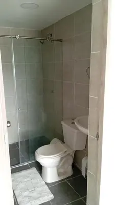 a bathroom with a toilet and a glass shower at Edificio Lotus Torices Cartagena in Cartagena de Indias