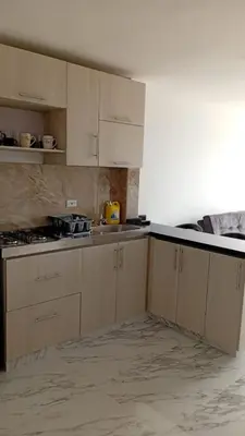 a kitchen with white cabinets and a counter top at Edificio Lotus Torices Cartagena in Cartagena de Indias