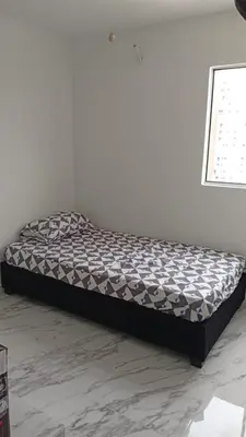 a bed sitting in a room with at Edificio Lotus Torices Cartagena in Cartagena de Indias