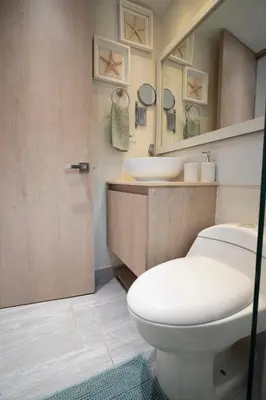 a bathroom with a white toilet and a sink at Refugio costero, Serena del Mar - Cartagena Indias in Serena del Mar
