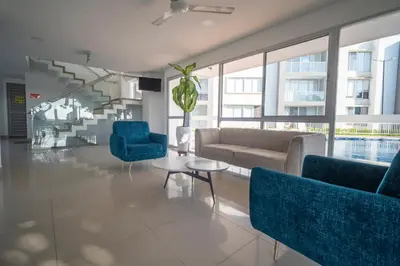 a living room with a couch and chairs and a table at Refugio costero, Serena del Mar - Cartagena Indias in Serena del Mar