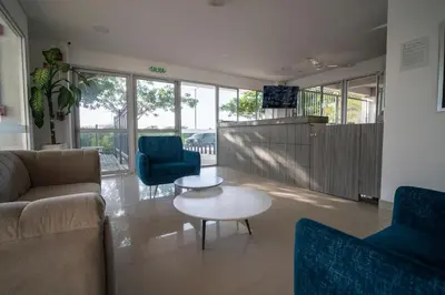 a living room with a couch and chairs and a table at Refugio costero, Serena del Mar - Cartagena Indias in Serena del Mar