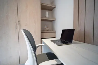 a laptop computer sitting on a table with two chairs at Refugio costero, Serena del Mar - Cartagena Indias in Serena del Mar