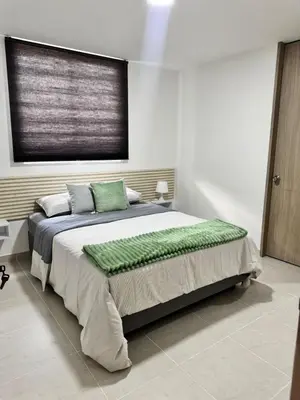 a bedroom with a large bed with a window at Baluarte de caribe 212 in Cartagena de Indias