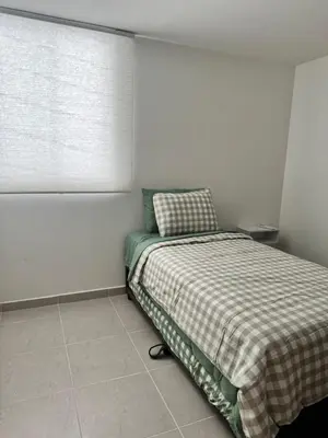 a small bedroom with a bed and a window at Baluarte de caribe 212 in Cartagena de Indias