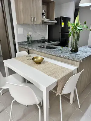 a kitchen with a white table and white chairs at Baluarte de caribe 212 in Cartagena de Indias