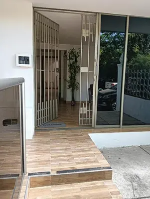 a front door of a house with a wooden floor at Dilla House in Cartagena de Indias
