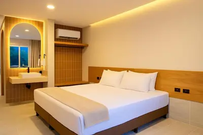 a bedroom with a large bed and a bathroom at Stanza Del Mar in Coveñas
