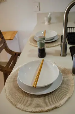 two white plates with chopsticks on a kitchen counter at Lujo y comodidad en Baia Kristal, Cartagena in Cartagena de Indias