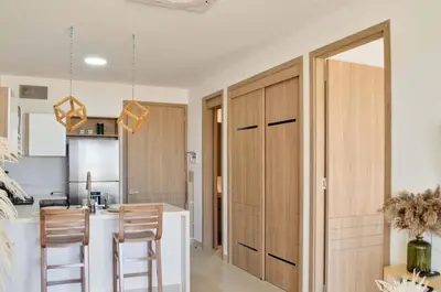 a kitchen with wooden cabinets and a kitchen island at Lujo y comodidad en Baia Kristal, Cartagena in Cartagena de Indias