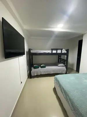 a bedroom with a bed and a flat screen tv at Cómodo & Económico Apartamento en La Boquilla Zona Norte Cartagena in Cartagena de Indias