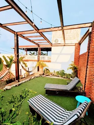 a patio with two lounge chairs on the grass at Duplex Colonial Getsemani in Cartagena de Indias