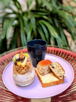 a plate with a breakfast sandwich and a cup of coffee at Duplex Colonial Getsemani in Cartagena de Indias