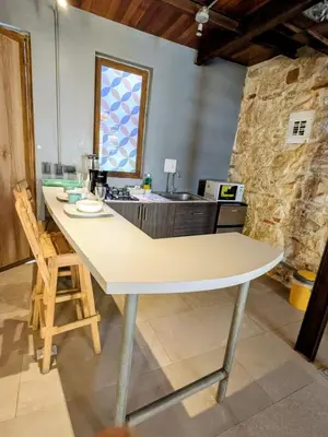 a kitchen with a large white island in a room at Duplex Colonial Getsemani in Cartagena de Indias