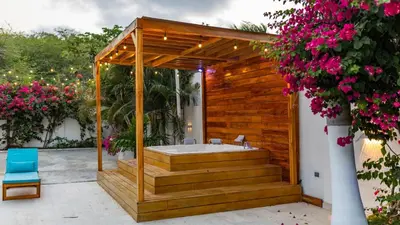 a bathroom with a soaking tub in a wooden deck at Casa Romero Cartagena Casa de Playa in Cartagena de Indias