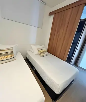 two beds in a small room with a window at Spectacular apartment, unparallel views! in Cartagena de Indias