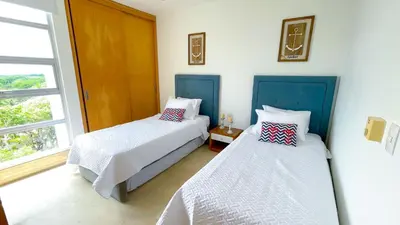 a bedroom with two beds and a window at Magico Apartamento Frente al Mar 3 Habitaciones TR72 in Coveñas