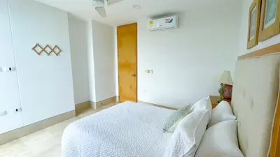 a white bedroom with a bed and a couch at Magico Apartamento Frente al Mar 3 Habitaciones TR72 in Coveñas