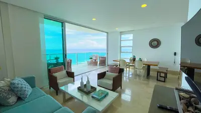 a living room with a blue couch and a table at Magico Apartamento Frente al Mar 3 Habitaciones TR72 in Coveñas