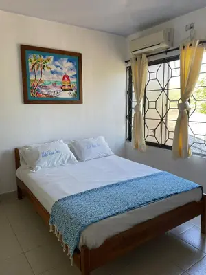 a bedroom with a bed in a room with a window at Casa Inés Tolú in Tolú