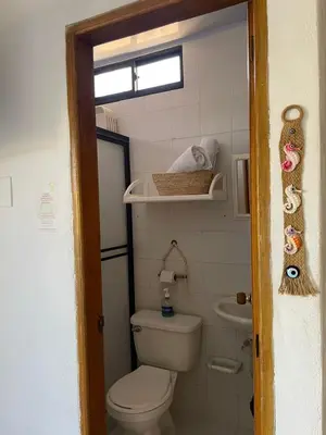 a small bathroom with a toilet and a sink at Casa Inés Tolú in Tolú