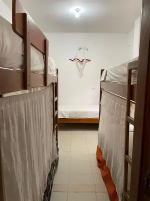 two bunk beds in a room with a bed at Casa Inés Tolú in Tolú