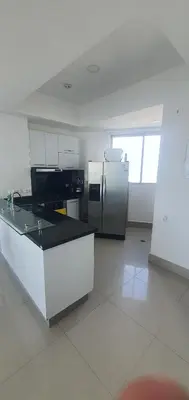 a kitchen with a refrigerator and a counter top at Lodging Apto 37 Palmetto Eliptic in Cartagena de Indias