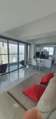 a living room with a large couch with a red pillow at Lodging Apto 37 Palmetto Eliptic in Cartagena de Indias