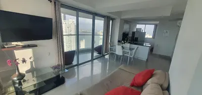 a living room with a couch and a large window at Lodging Apto 37 Palmetto Eliptic in Cartagena de Indias