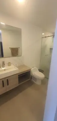 a bathroom with a toilet and a sink and a mirror at Lodging Palmetto apto 4 Bocagrande in Cartagena de Indias