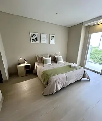 a bedroom with a large bed and a large window at Fantástico apartamento 505 in Cartagena de Indias