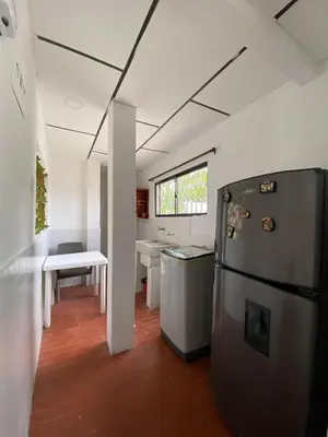 a kitchen with a refrigerator and a sink at Acogedor apartamento excelente ubicación in Barranquilla