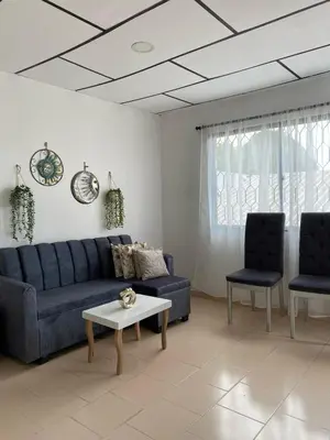 a living room with a blue couch and two chairs at Acogedor apartamento excelente ubicación in Barranquilla