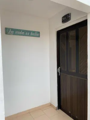 a door to a building with a sign on it at Acogedor apartamento excelente ubicación in Barranquilla
