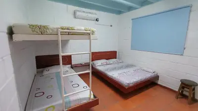 a room with two bunk beds and a window at Monkey man, Beach House in Santa Marta