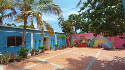 a building with a mural on the side of it at Monkey man, Beach House in Santa Marta