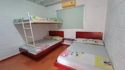a room with two bunk beds and a mirror at Monkey man, Beach House in Santa Marta