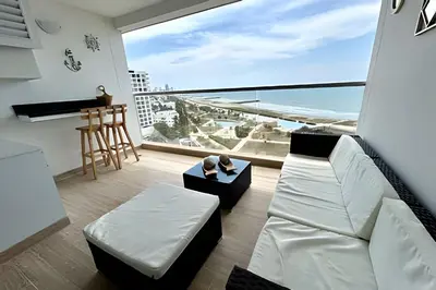 a living room with a white couch and a large window at Suite con Vista al Mar en Cartagena 1106CB in Cartagena de Indias