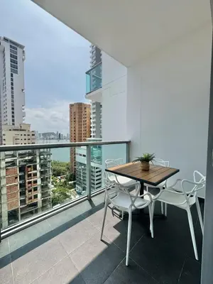 a table and chairs on a balcony with a view at Apartamento con hermosa vista en Bocagrande in Cartagena de Indias