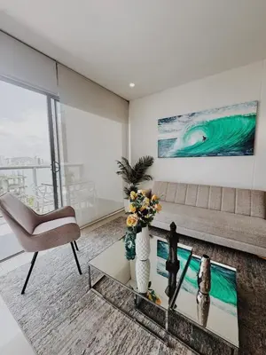 a living room with a couch and a chair at Apartamento con hermosa vista en Bocagrande in Cartagena de Indias